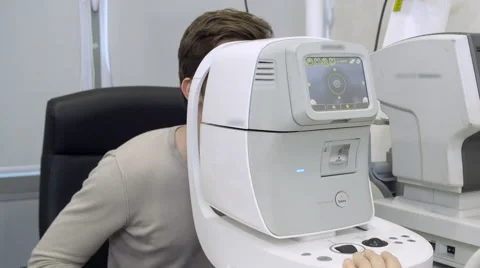 Doctor excaminating man's vision using machine Stock Footage 62348083