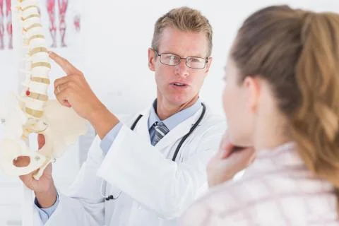 Doctor explaining anatomical spine to his patient Stock Photos