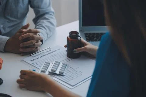 Doctor explaining brain functions to patient on model in office. Stock Photos