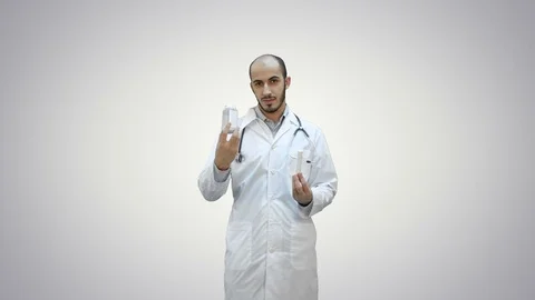 Doctor explaining difference between the pills on white background Stock Footage 73636214