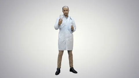 Doctor explaining difference between two bottles of pills on white background Stock Footage 73644387