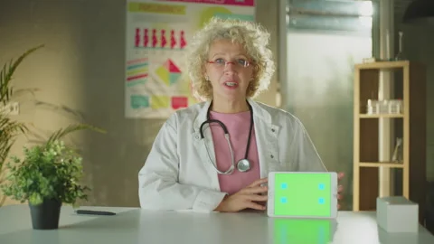 Doctor explaining in a green screen tablet Stock Footage 221271185
