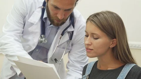 The doctor is explaining his recommendations to the patient Stock Footage 80288284