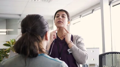 Doctor explaining lymph nodes to patient in clinic Stock Footage 221035438