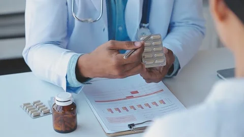 Doctor explaining medication to patient during appointment close up Stock Footage 325420813
