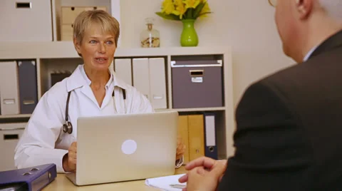 Doctor explaining medication to patient Stock Footage 34372541