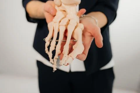 Doctor explaining operation to foot on bone model Stock Photos