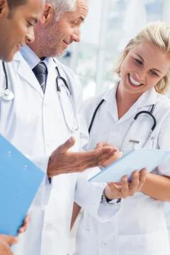 Doctor explaining something in his tablet Stock Photos