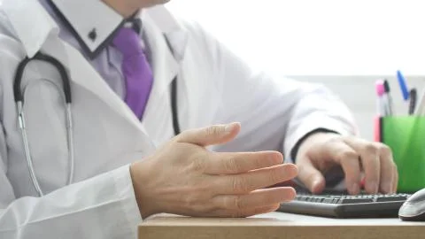 A doctor explaining something by making hands gestures. Stock Photos