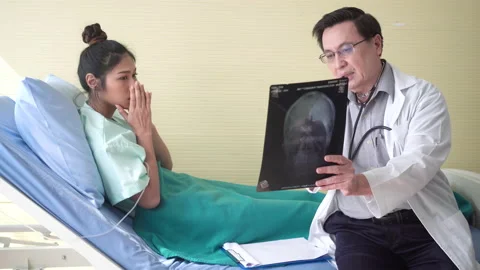The doctor explaining x-ray scan of human head.The patient was  sad. Stock Footage 141035877