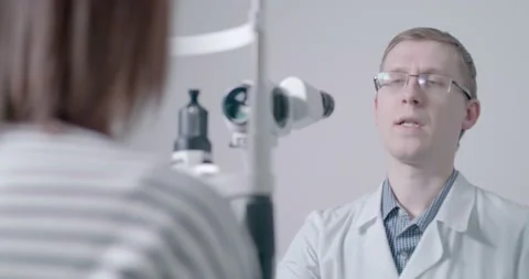 The doctor explains the procedure for checking eyesight Stock Footage 90267689
