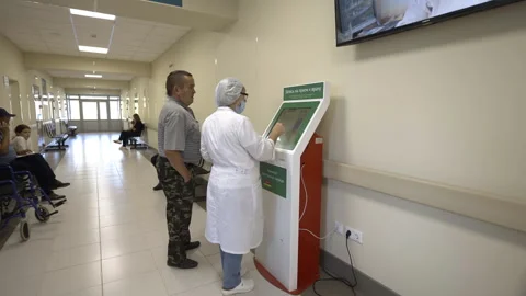 Doctor explains various payment methods accepted by terminal Stock Footage 280913140