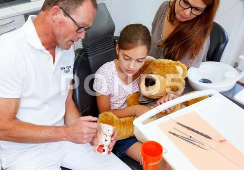 A doctor explains a young family mother and kind how you can care the teeth Stock Photos