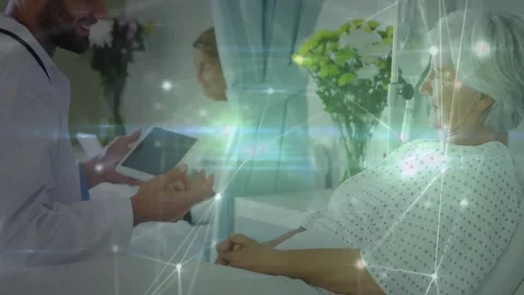 Doctor extending tablet to elderly patient, scrolling health data with overlay Stock Footage 325702836