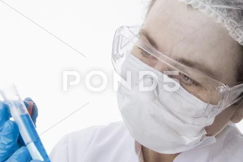 Doctor In Face Mask Using Tablet Computer