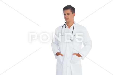 Doctor frowning with hands in pocket Stock Photos