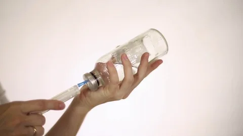 The doctor gaining in a syringe medication Stock Footage 79840876