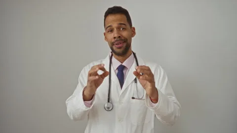 Doctor gesturing okay with hands wearing white coat and stethoscope against.. Stock Footage 310629440