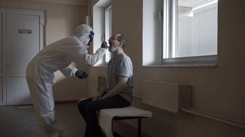 Doctor getting saliva test sample using a swab Stock Footage 127704531