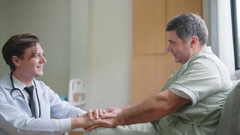 Doctor give help support handicapped old patient happy sitting in hospital Stock Footage 196774936