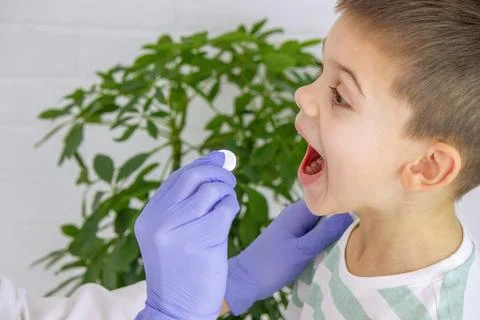 Doctor giving ascorbic or vitamin to boy. Pediatrician's appointment, healt.. Stock Photos