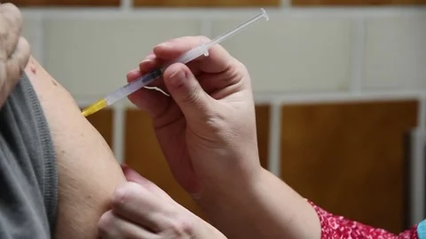 Doctor giving coronavirus vaccine Stock Footage