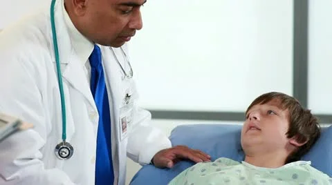 Doctor giving nurse instructions for boys condition Stock Footage