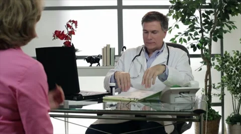 Doctor giving a prescription to patient Stock Footage