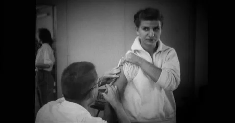 Doctor giving vaccination to flood victim Stock Footage