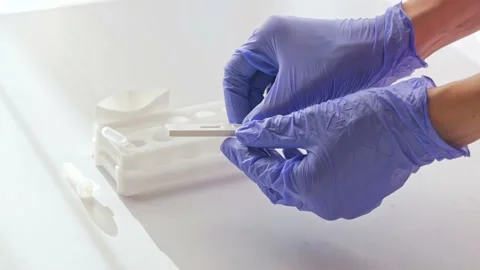 Doctor in gloves show negative test result by using rapid test device for COVID- Stock Footage 165070924