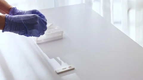Doctor in gloves unscrew buffer bottle, press all drops on extraction test tube Stock Footage 165070769