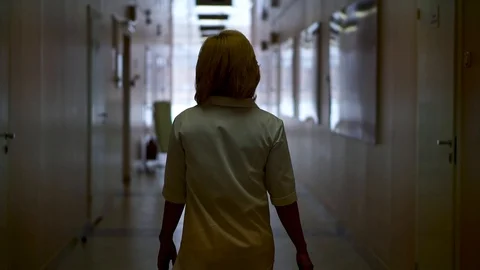 The doctor goes down the corridor. The view from the back Stock Footage 104661371