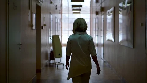 The doctor goes down the corridor. The view from the back Stock Footage 104661414