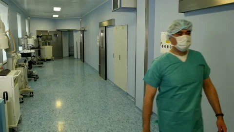 Doctor goes down the hall in the operating unit Video stock 107130479