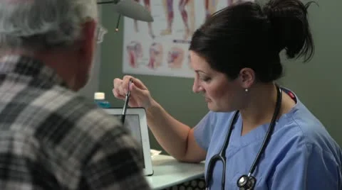 Doctor going over x-ray results with patient Stock Footage