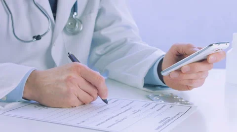 Doctor hand holding and using a smartphone Stock Footage 56458437