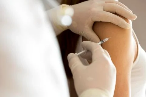 Doctor hand make patient insulin flu shot by syringe subcutaneous arm injecti Stock Photos