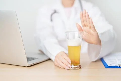 Doctor hand stop to refuse Beer, quitting drink for healthy liver, prevent .. Stock Photos
