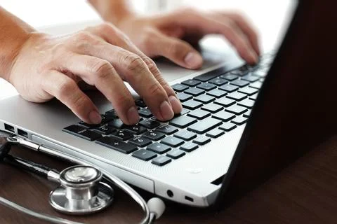 Doctor hand working with laptop computer in medical workspace office as conce Stock Photos
