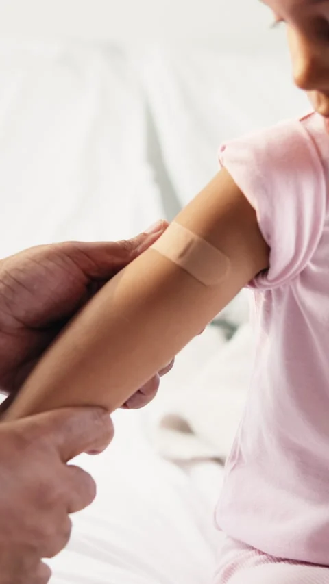 Doctor, hands and kid with plaster on bed for immunization or medical injection Stock Footage 335740407