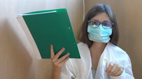 The doctor hands over a folder with case histories Stock Footage 138684418