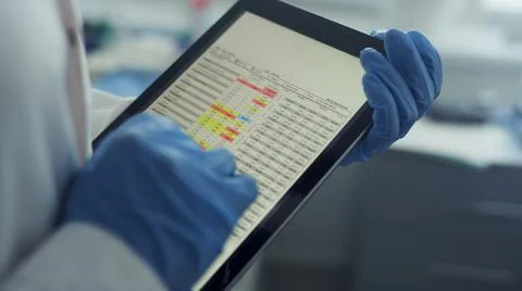 Doctor hands using tablet checking health history data in tablet in office. Stock Photos