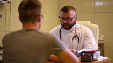 Doctor having an appointment and questioning the patient Stock Footage 77885429