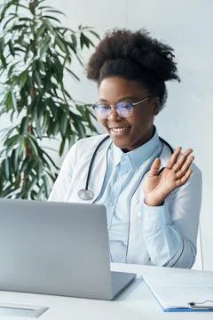 Doctor having videocall zoom online chat with patient using laptop computer Stock Photos