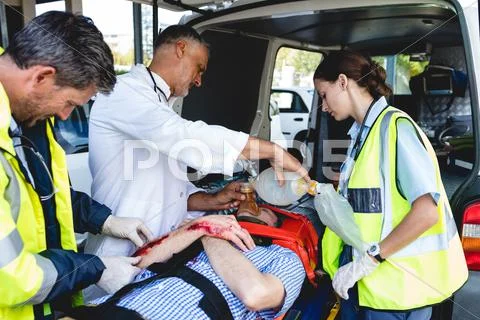 Doctor Healing Injured Man In Ambulance Car