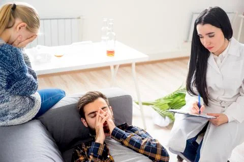 Doctor helping an alcoholic Stock Photos