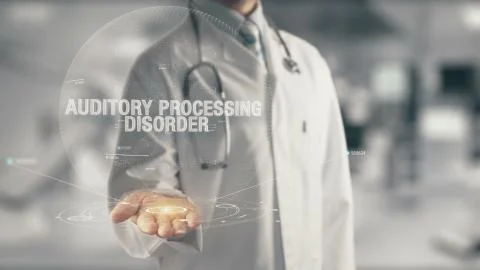 Doctor holding in hand Auditory Processing Disorder 库存照片