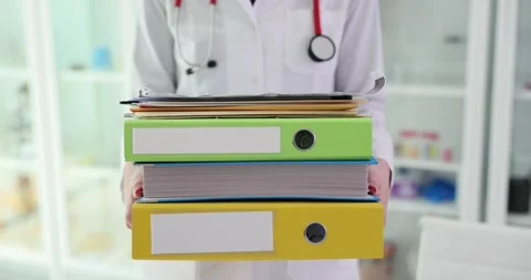 Doctor is holding large stack of folders and medical documents Stock Footage 243269085