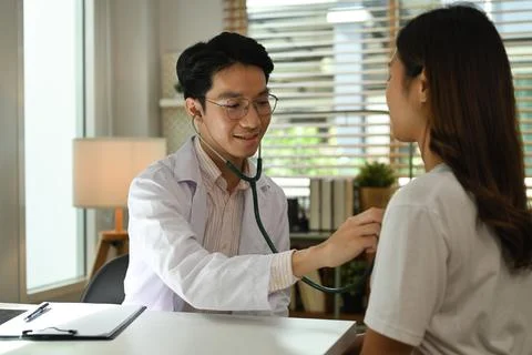 Doctor holding stethoscope examine checking heart lungs of patient in hospital Stock Photos