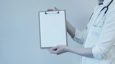 The doctor holds in his hands a folder for notes Stock Footage 248307253